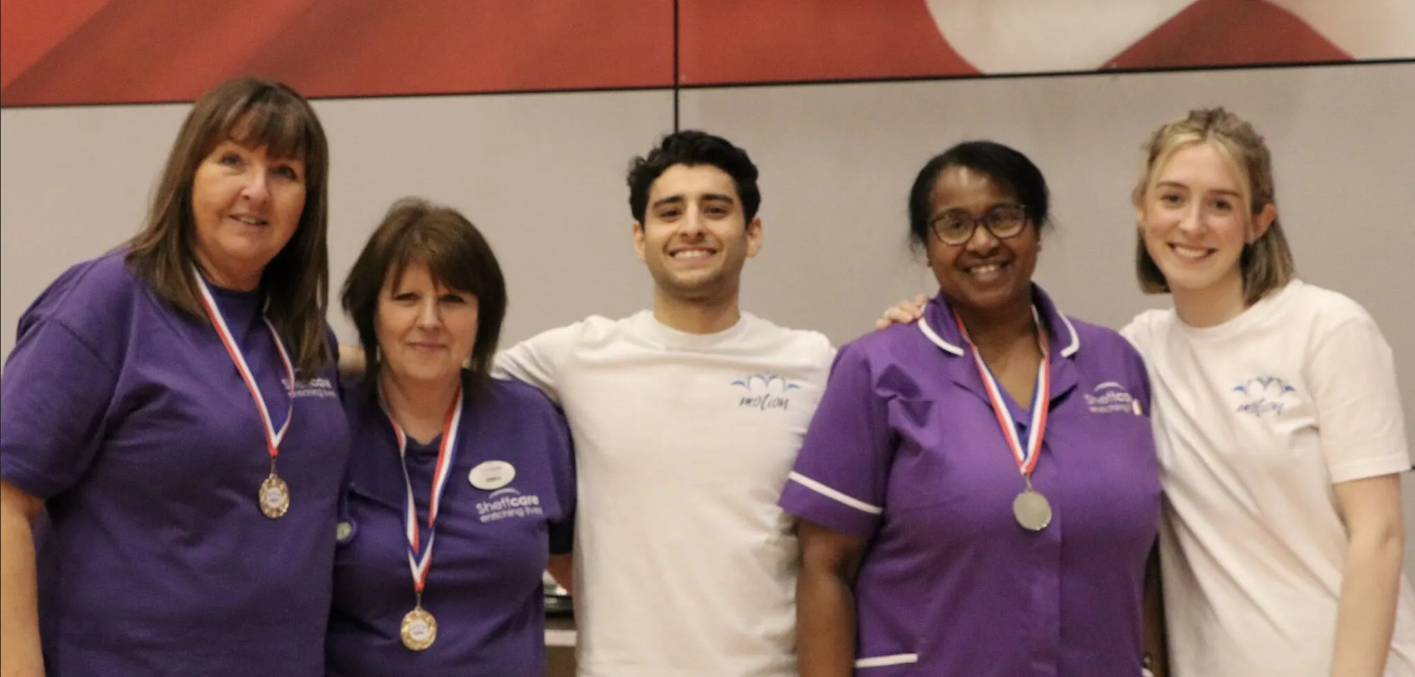 The Motion team standing with care staff